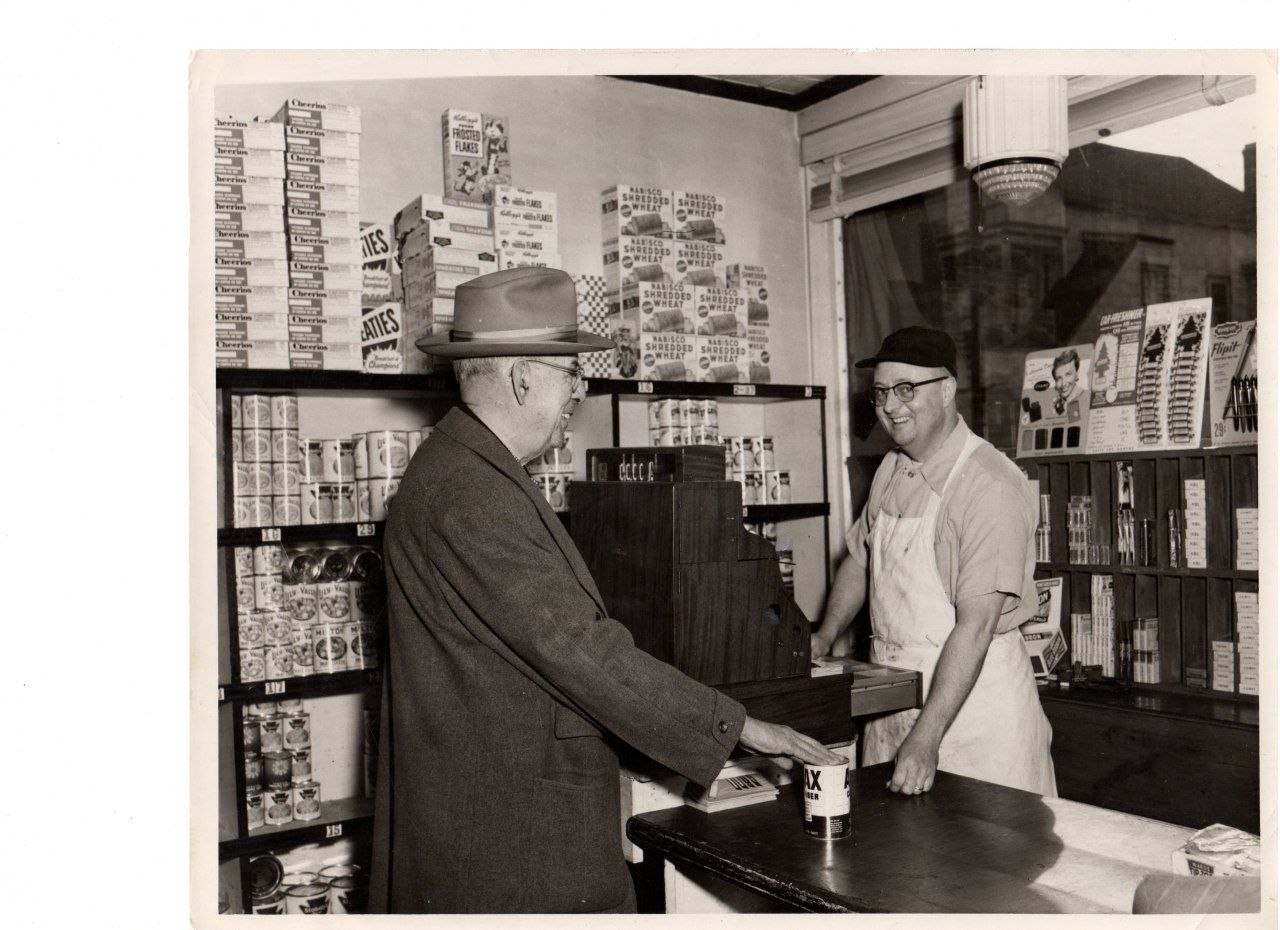Maurice Goulet behind the counter at Howard Street Market, 1950s